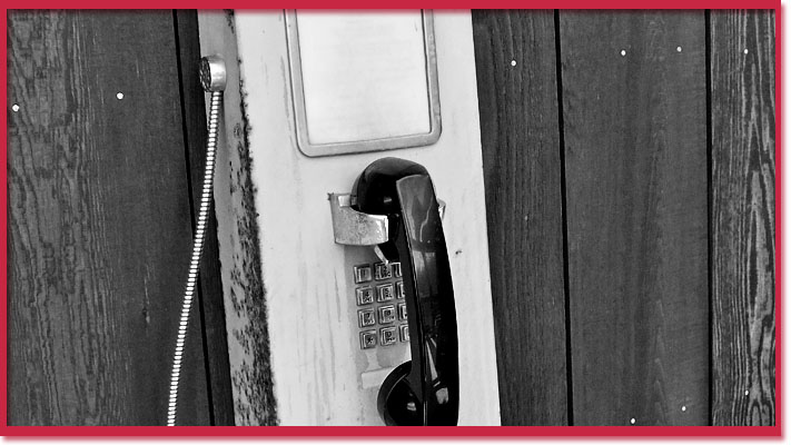 Black and white photo of payphone